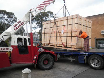 timber packaging for machinery being loaded to truck